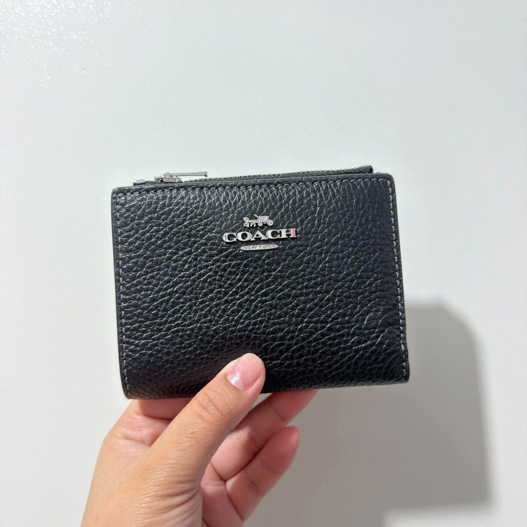 Coach PBL LTR BIFLD WLT Black Wallet (Category: Wallets & Card holders) located in Cabanatuan. Submitted by luckypenguin.e2a414 (Listing ID 1469245508, Image 1). Description: - Authentic Coach bifold wallet in classic black pebble leather - Brand new with original retail price tag attached - Convenient side zip coin pocket and secure snap closure - Multiple card slots and spacious cash compartment - Sleek silver-tone hardware and clean interior l