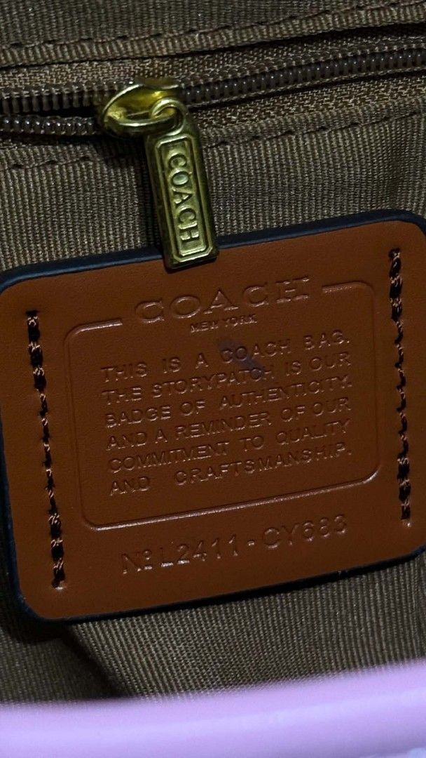 Coach Pink Signature Shoulder Bag (Category: Luxury Bags & Wallets) located in Cavite. Submitted by loriojenni09117 (Listing ID 1469700438, Image 2). Description: - Brand: Coach - Color: Light pink signature canvas with gold-tone hardware - Straps: Includes a short handle and a removable matching shoulder strap - Accent: Adorable cherry charm attached to the side ring - Interior: Brown fabric lining with a secure zipper pocket and classic story p