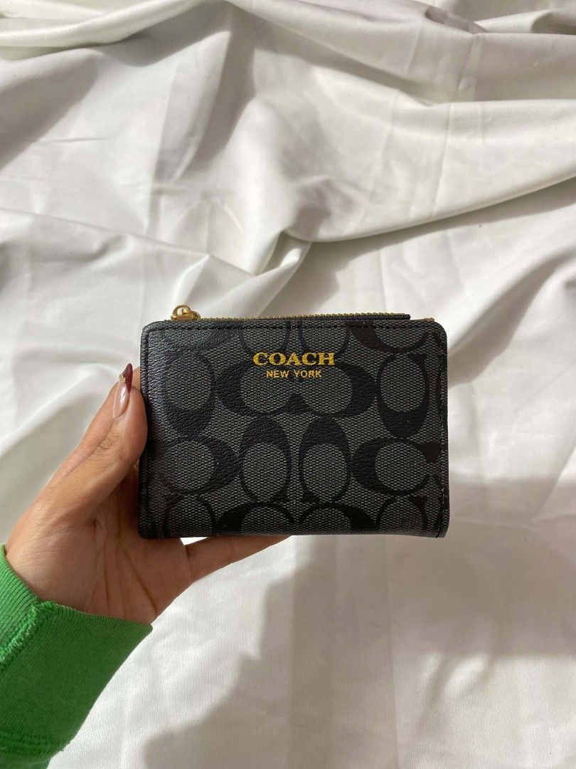 Coach Signature C Bi-fold Zip Wallet (Category: Wallets & Card holders) located in Manila. Submitted by bloomsbeaute (Listing ID 1469744185, Image 3). Description: - Authentic Coach compact wallet with classic signature C monogram - Top zippered compartment for coins and folded cash - Secure snap closure opens to multiple card slots and a clear ID window - Perfectly sized to fit easily into small bags or pockets - Available colors: Metallic Gold,