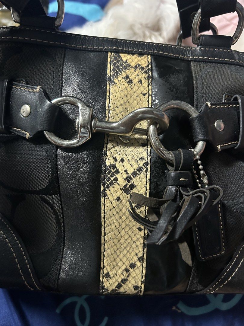 Coach Signature C Python Print Trim Tote Bag (Category: Luxury Bags & Wallets) located in Paombong. Submitted by ofel315 (Listing ID 1469656941, Image 2). Description: - Authentic Coach shoulder bag with iconic signature C canvas and chic black leather panels - Features a bold snakeskin center stripe and polished silver hardware - Secure dog leash closure and comfortable double shoulder straps - Includes a stylish hanging leather tassel charm - C