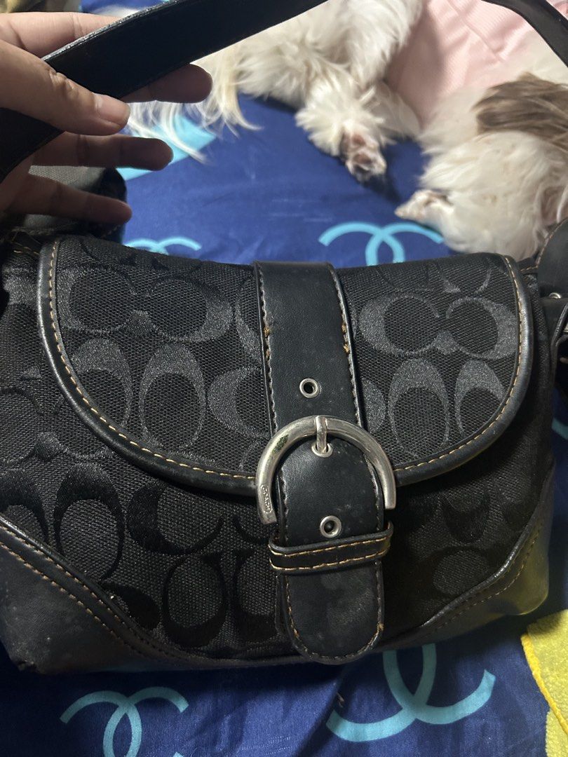 Coach Signature Monogram Black Shoulder Bag (Category: Luxury Bags & Wallets) located in Paombong. Submitted by ofel315 (Listing ID 1469658221, Image 2). Description: - Brand: Coach - Style: Y2K signature monogram shoulder bag - Color: Classic black with contrast stitching - Material: Monogram fabric with leather trim and silver-tone hardware - Closure: Front buckle closure - Condition: Good, with minor scuffs on the leather trim at the corners -