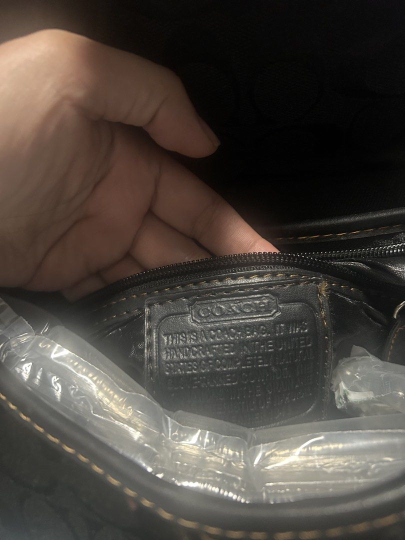 Coach Signature Monogram Black Shoulder Bag (Category: Luxury Bags & Wallets) located in Paombong. Submitted by ofel315 (Listing ID 1469658221, Image 3). Description: - Brand: Coach - Style: Y2K signature monogram shoulder bag - Color: Classic black with contrast stitching - Material: Monogram fabric with leather trim and silver-tone hardware - Closure: Front buckle closure - Condition: Good, with minor scuffs on the leather trim at the corners -