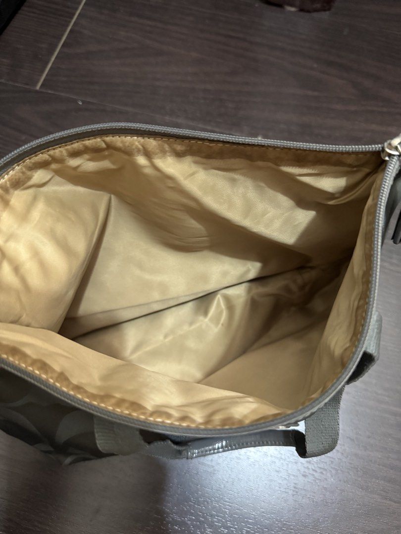 Coach Signature Nylon Tote Bag (Category: Luxury Bags & Wallets) located in Las Pinas. Submitted by nickelcloset (Listing ID 1469607049, Image 3). Description: - Authentic Coach small you can fold - Features the iconic all-over signature C monogram pattern - Secure top zip closure.