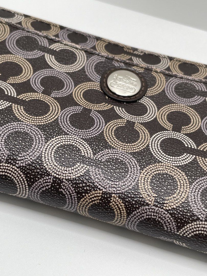Coach Signature Optic Dot Zip Around Wallet (Category: Wallets & Card holders) located in Mandaluyong City. Submitted by akihabara48 (Listing ID 1469586224, Image 2). Description: Issue: interior leather is sticky/has melting, lining has hole (see pic) - Authentic Coach dark brown wallet with dotted optic C pattern - Silver-tone hardware and Coach Est. 1941 horse and carriage medallion on front slip pocket - Secure zip-around closure with a match