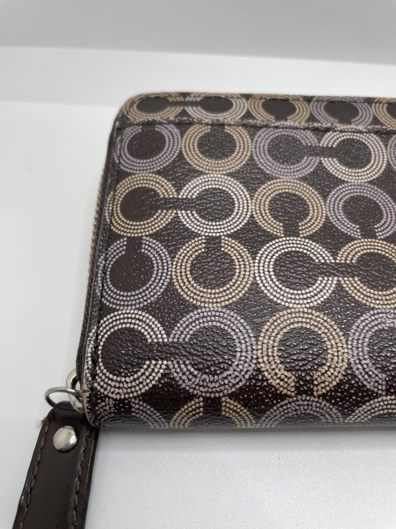Coach Signature Optic Dot Zip Around Wallet (Category: Wallets & Card holders) located in Mandaluyong City. Submitted by akihabara48 (Listing ID 1469586224, Image 3). Description: Issue: interior leather is sticky/has melting, lining has hole (see pic) - Authentic Coach dark brown wallet with dotted optic C pattern - Silver-tone hardware and Coach Est. 1941 horse and carriage medallion on front slip pocket - Secure zip-around closure with a match