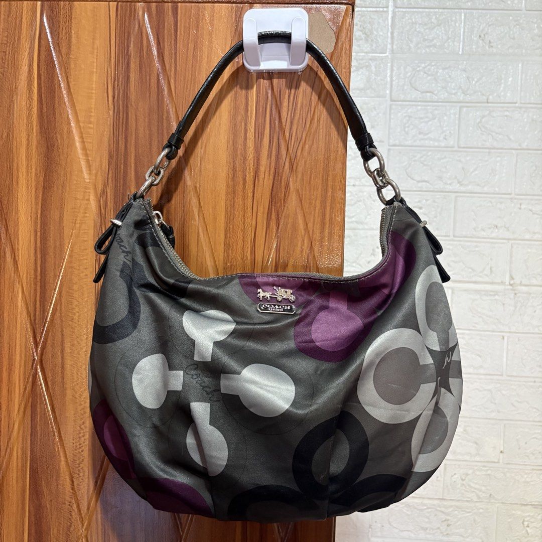 Coach Signature Patchwork Hobo Shoulder Bag (Category: Luxury Bags & Wallets) located in Carmen. Submitted by rr_thrifts (Listing ID 1469590865, Image 1). Description: - Authentic Coach signature patchwork hobo shoulder bag - Eye-catching gray, white, and purple colorway with large C patterns and script logo - Elegant silver-tone hardware with front horse and carriage metal plaque - Single black leather strap accented with stylish chain links - S