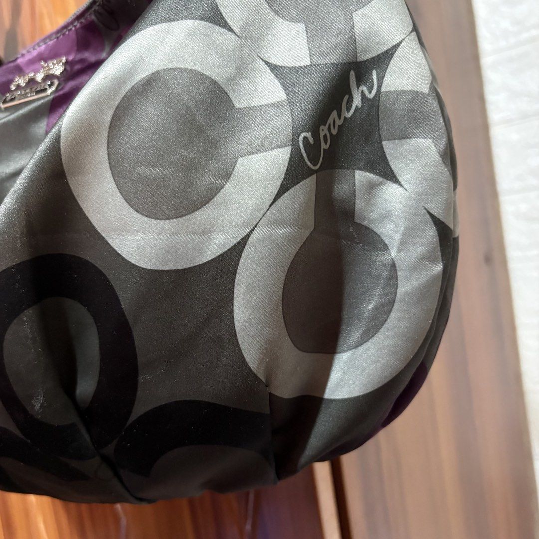Coach Signature Patchwork Hobo Shoulder Bag (Category: Luxury Bags & Wallets) located in Carmen. Submitted by rr_thrifts (Listing ID 1469590865, Image 3). Description: - Authentic Coach signature patchwork hobo shoulder bag - Eye-catching gray, white, and purple colorway with large C patterns and script logo - Elegant silver-tone hardware with front horse and carriage metal plaque - Single black leather strap accented with stylish chain links - S