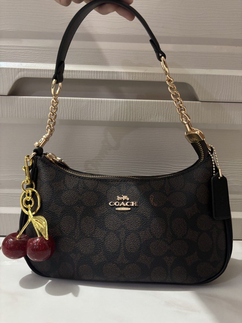 Coach Terri Shoulder Bag with Cherry Charm (Category: Luxury Bags & Wallets) located in Santa Maria. Submitted by janelombres27 (Listing ID 1469680658, Image 1). Description: no minor & major flaws never been used negotiable can do meetups around sta.maria bulacan for pickup: lalamove/jnt (sf will be shouldered by buyer) mop: gcash/maribank/unionbank/maya RUSH rfs: need extra funds for my tuition. .