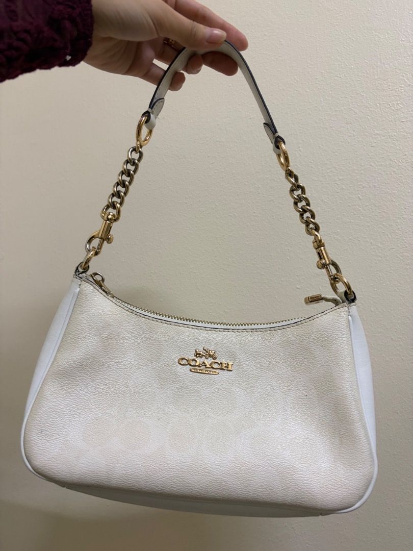 Coach White Leather Shoulder Bag (Category: Luxury Bags & Wallets) located in Quezon City. Submitted by silentstar.3e0b05 (Listing ID 1469612896, Image 1). Description: - Brand: Coach - Color: Classic White with luxurious gold-tone hardware - Material: Premium leather featuring a subtly embossed monogram pattern - Strap: Elegant chain-link detail for a chic look - Closure: Secure zip-top closure to keep your belongings safe - Interior: Clean lini