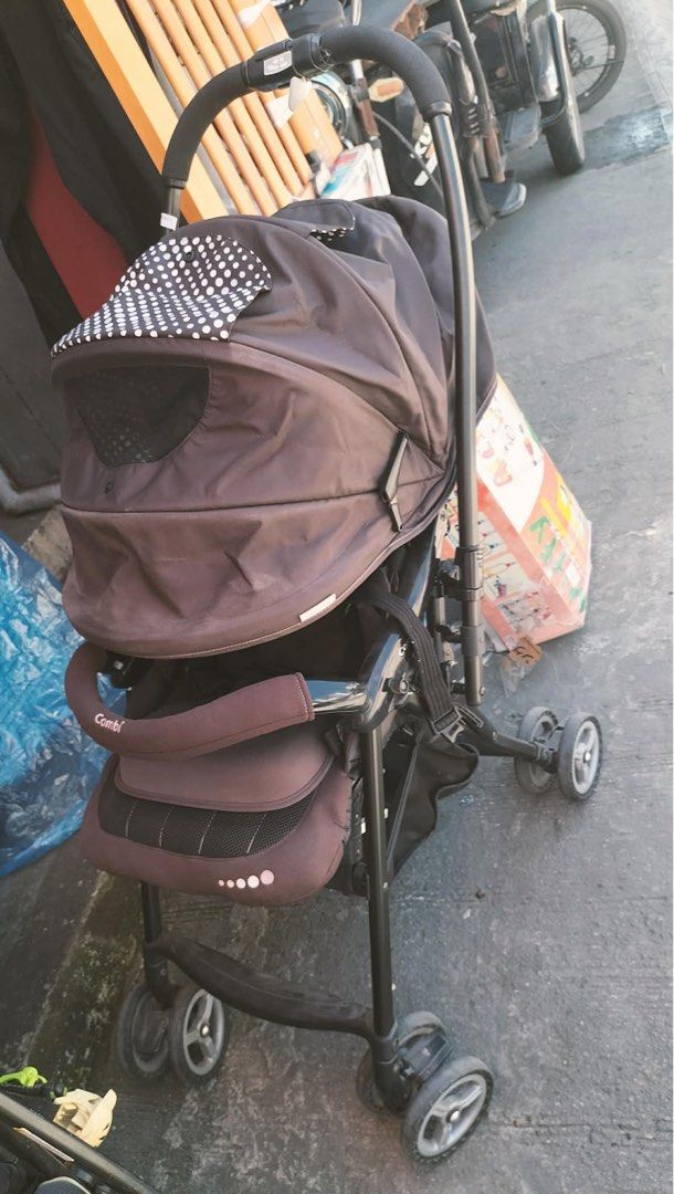 Combi Baby Stroller Brown with Polka Dot Canopy (Category: Strollers) located in Calamba. Submitted by rhiajapansurplus-babystuff-03 (Listing ID 1469749420, Image 2). Description: - Brand: Combi Baby Stroller - Color: Dark Brown with white polka dot interior canopy - Comfort: Includes padded seat insert and head support - Safety: Equipped with secure safety harness and branded front bumper bar - Features: Breathable mesh ventilation panel on cano