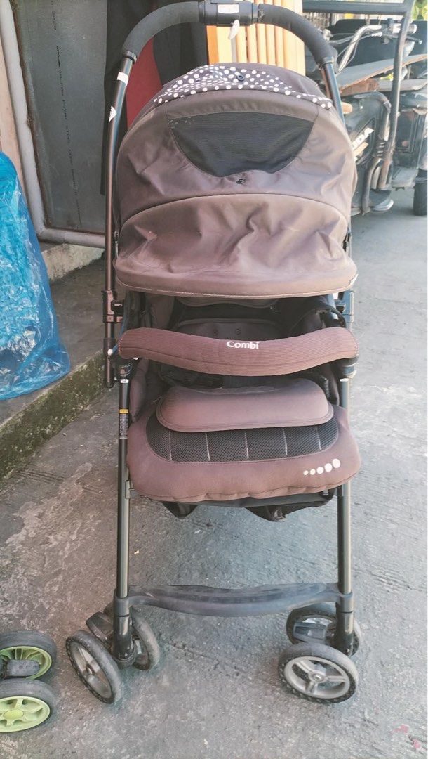 Combi Baby Stroller Brown with Polka Dot Canopy (Category: Strollers) located in Calamba. Submitted by rhiajapansurplus-babystuff-03 (Listing ID 1469749420, Image 3). Description: - Brand: Combi Baby Stroller - Color: Dark Brown with white polka dot interior canopy - Comfort: Includes padded seat insert and head support - Safety: Equipped with secure safety harness and branded front bumper bar - Features: Breathable mesh ventilation panel on cano