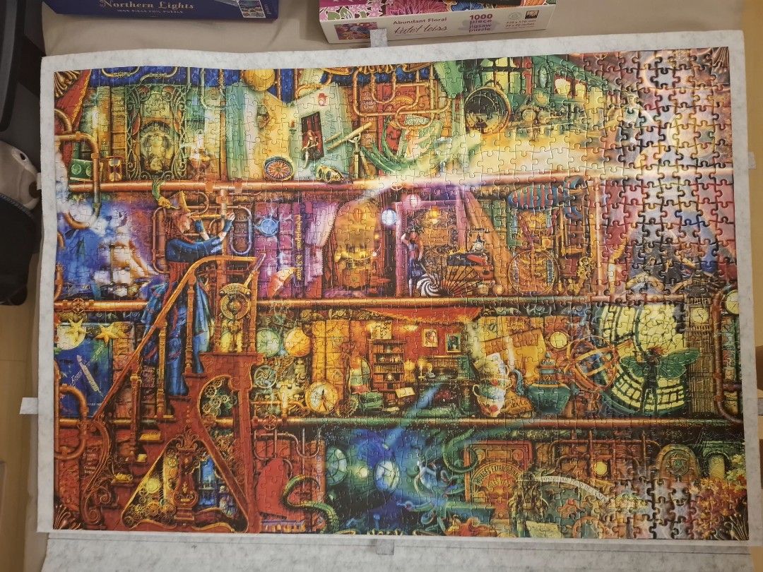 Completed 1000-piece Steampunk Library Jigsaw Puzzle (Category: Board Games & Puzzles) located in Quezon City. Submitted by helenachan88 (Listing ID 1469625818, Image 1). Description: - Completed 1000-piece puzzle featuring a vibrant steampunk library shelf design - 100% complete set with all pieces intact and accounted for - Packed with intricate details like gears, books, and multi-level characters - Perfect for puzzle enthusiasts looking for a