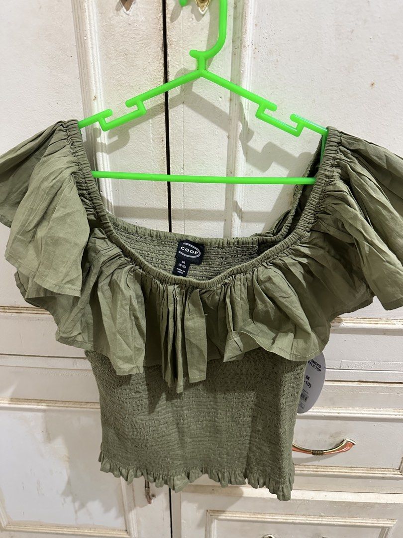 COOP Smocked Ruffle Top Green Mist Size M (Category: Sleeveless) located in Bugallon. Submitted by lavenderlane (Listing ID 1469709912, Image 1). Description: - Brand: Coop - Size: M (8-10) - Condition: Brand new with original tag attached - Material: Super comfy and stretchy - Design: Square neckline, short ruffle sleeves, smocked bodice - Color: Green - Perfect for casual days out.