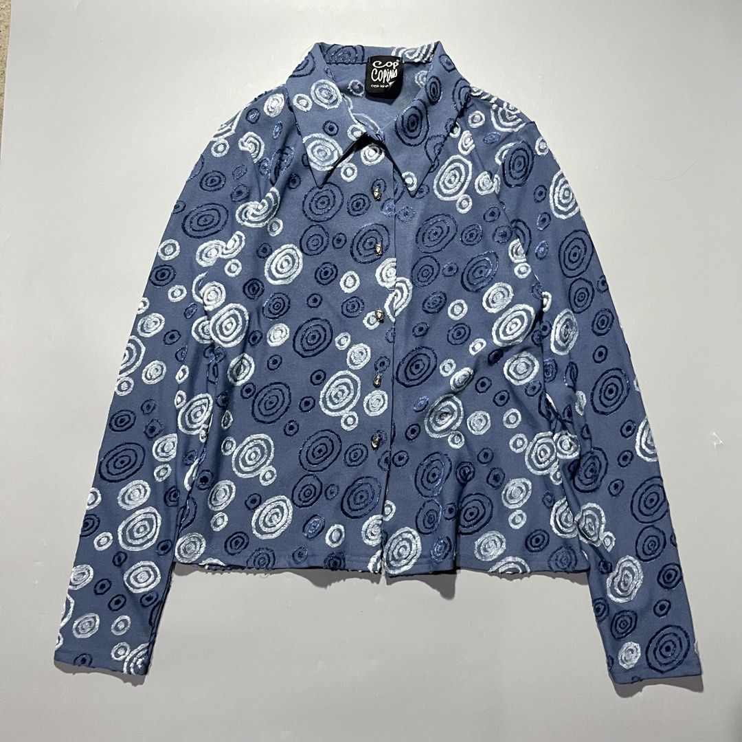 Cop Copine Blue Swirl Pattern Long Sleeve Button Up Shirt (Category: Longsleeves) located in Iloilo. Submitted by kahit.ano.na.lang (Listing ID 1469736989, Image 1). Description: - Brand: Cop Copine (Vintage) - Color: Dusty blue - Design: Textured swirl and spiral pattern throughout - Details: Classic collar neckline, unique metallic face buttons - Fabric: Soft, stretchy material for a comfortable fit - Condition: Great vintage piece.