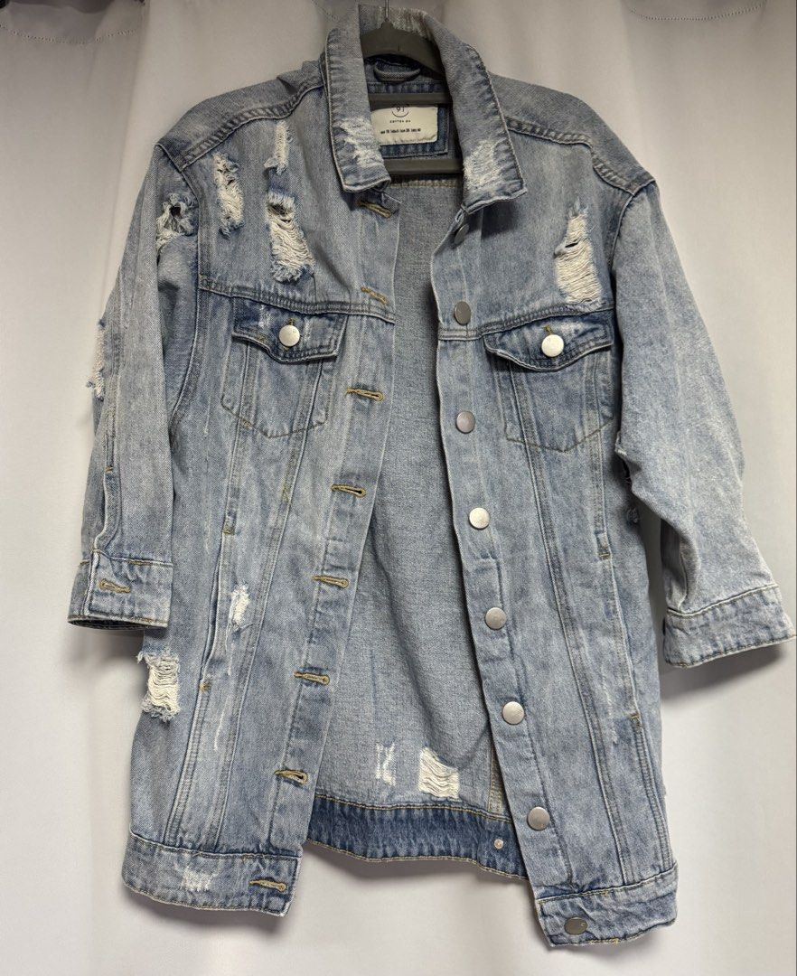 Cotton On Distressed Denim Jacket Size AUS 10 (Category: Coats, Jackets and Outerwear) located in Calamba. Submitted by cheriiv (Listing ID 1469724458, Image 2). Description: - Brand: Cotton On - Style: Light wash denim jacket with heavy distressing on shoulders and back hem - Fit: Oversized, perfect for layering - Details: Button-up front, silver hardware, chest pockets, and side pockets - Size: AUS 10, US 6, EUR 38 (Medium).