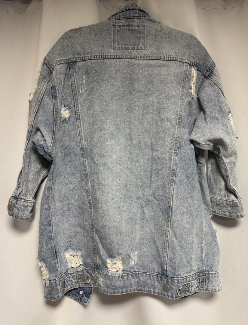 Cotton On Distressed Denim Jacket Size AUS 10 (Category: Coats, Jackets and Outerwear) located in Calamba. Submitted by cheriiv (Listing ID 1469724458, Image 3). Description: - Brand: Cotton On - Style: Light wash denim jacket with heavy distressing on shoulders and back hem - Fit: Oversized, perfect for layering - Details: Button-up front, silver hardware, chest pockets, and side pockets - Size: AUS 10, US 6, EUR 38 (Medium).