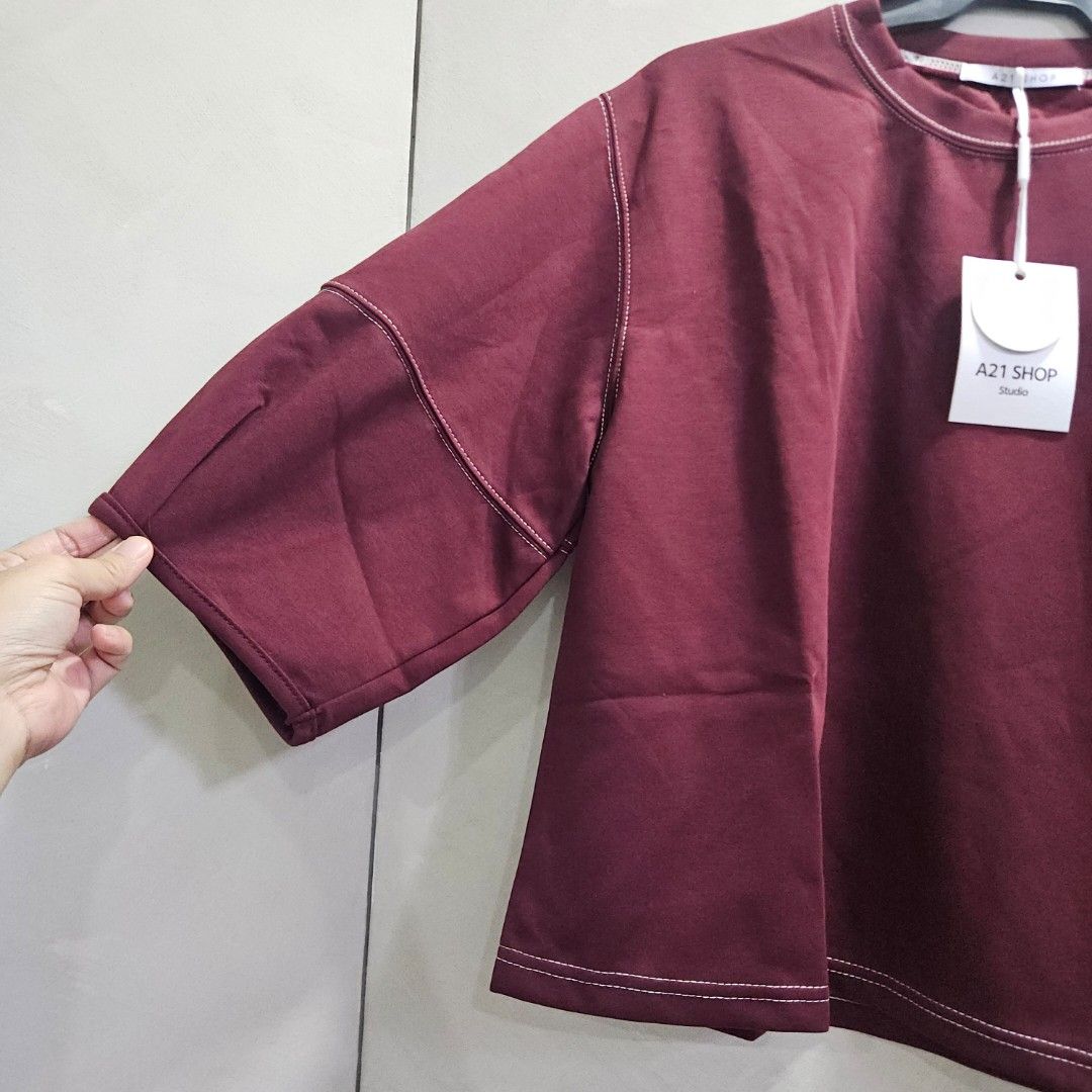 Crewneck 3/4 balloon sleeves top (Category: Others Tops) located in Quezon City. Submitted by k_closetsale (Listing ID 1469643812, Image 3). Description: wine-colored crewneck oversized top featuring 3/4 balloon sleeves with pleated cuffs and contrast white stitching, branded by A21 Shop Studio fits up to XL.