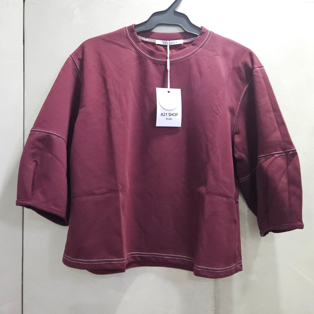 Crewneck 3/4 balloon sleeves top (Category: Others Tops) located in Quezon City. Submitted by k_closetsale (Listing ID 1469643812, Image 1). Description: wine-colored crewneck oversized top featuring 3/4 balloon sleeves with pleated cuffs and contrast white stitching, branded by A21 Shop Studio fits up to XL.