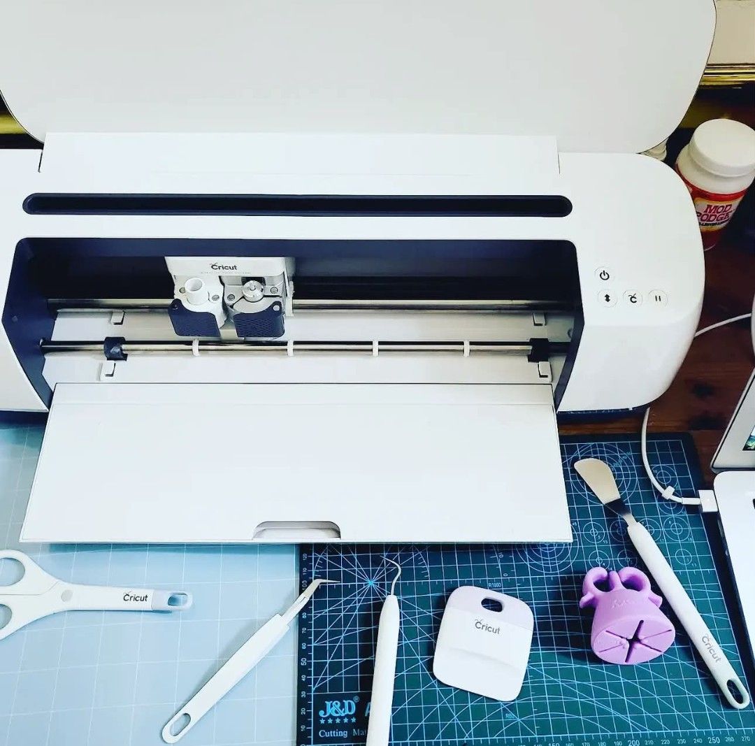 Cricut Maker Cutting Machine Bundle with Tools and Accessories (Category: Craft Supplies & Tools) located in San Luis. Submitted by laramei.0827 (Listing ID 1469627102, Image 1). Description: - Cricut Maker machine in original packaging - Includes cutting mat, scraper, weeding tools, spatula, and scissors - Comes with extra blades, vinyl sheets, transfer paper rolls, and Mod Podge - Ideal for crafting, decals, and custom apparel projects - Clean,