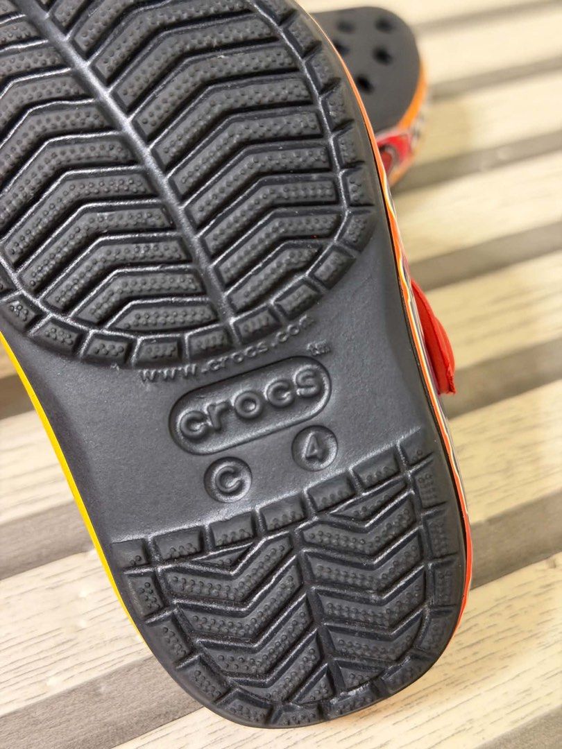 Crocs Lightning McQueen Kids Clogs Size C4 (Category: Babies & Kids Fashion) located in Manila. Submitted by bizfits_ (Listing ID 1469618473, Image 2). Description: - Authentic Disney Cars Lightning McQueen design with number 95 graphics - Color: Black with bright red heel strap and yellow accents - Features ventilation holes on top for breathability - Easy slip-on style perfect for kids - Clear sizing info on the bottom sole - Condition: [Insert