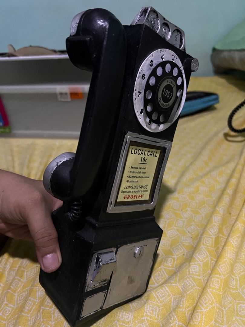 Crosley 1957 Public Telephone Decor Piece (Category: Vintage Collectibles) located in Caloocan City. Submitted by mherckyyragkee (Listing ID 1469676584, Image 2). Description: - Authentic Crosley retro public telephone replica - Stylish black body with striking silver accents - Classic rotary dial design with realistic coin slot and return - Features a vintage 10-cent local call instructional placard - Solid decorative statement piece for retro a