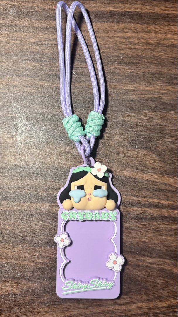 Cry Baby ID lace (Category: Plushies & Soft Toys) located in Makati City. Submitted by khyfra25 (Listing ID 1469631662, Image 1). Description: - Authentic Pop Mart Cry Baby design - Color: Pastel purple with mint accents - Material: Durable and soft rubber/silicone card holder with a sturdy woven lanyard - Condition: Brand new - Features adorable Cry Baby character graphics with floral details - Ideal for office IDs, school badges, or transit car
