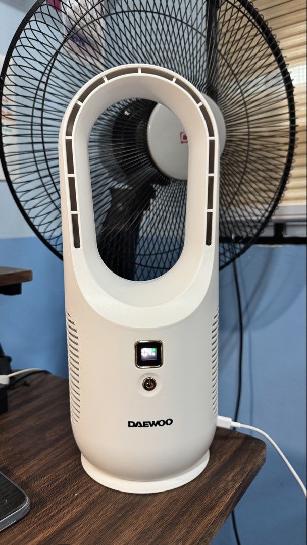 Daewoo Bladeless Desk Fan (Category: Fans) located in Makati City. Submitted by khyfra25 (Listing ID 1469635279, Image 1). Description: - Daewoo bladeless tower fan in a clean white, modern oval design - Features a digital display screen showing battery percentage - Easy-to-use single power button located right below the screen - Convenient pluggable charging cable attached on the right side - Compact and space-saving, sits easily on any desk or 