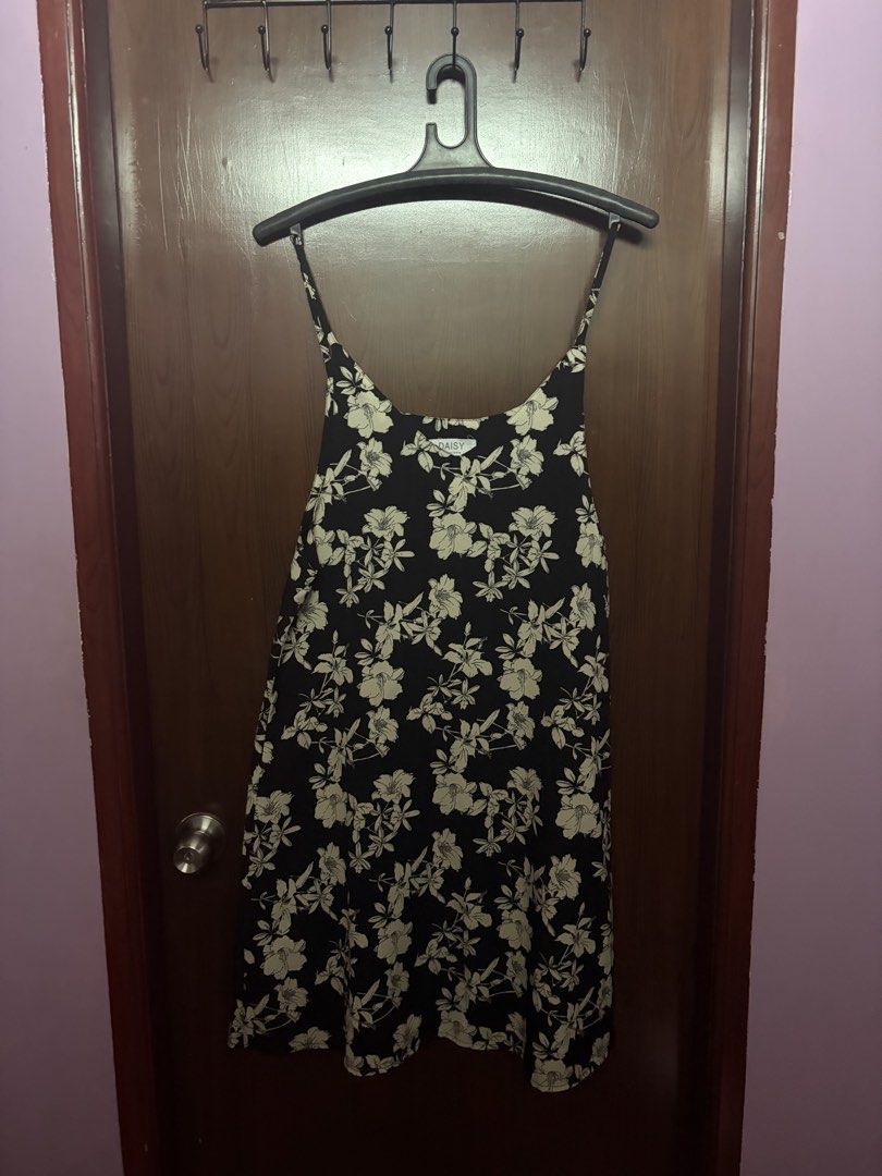 Daisy Black Floral Spaghetti Strap Dress (Category: Dresses) located in Navotas City. Submitted by fujikooooooo (Listing ID 1469703946, Image 1). Description: - Nice overtop dress, never been used - Style: Black slip dress with cream floral pattern - Straps: Spaghetti straps, simple slip-on fit - Length: Mid-thigh - Material: Lightweight fabric - Condition: Clean and well-kept.