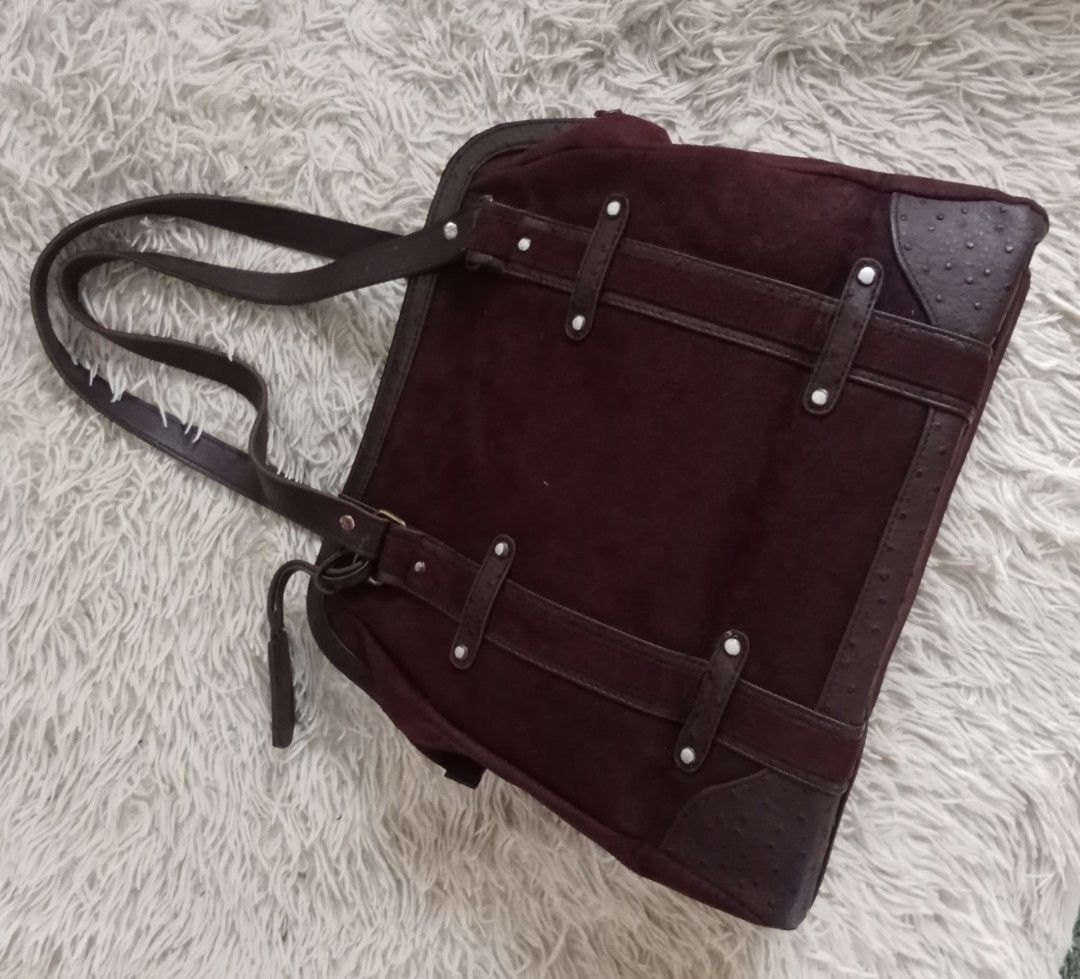 Dark brown suede tote bag with textured straps (Category: Tote Bags) located in Caloocan City. Submitted by noy5o1a (Listing ID 1469636790, Image 2). Description: - Dark brown suede tote bag with structured silhouette - Textured faux ostrich leather trim on base, corners, and handles - Secure zip-top closure - Double shoulder straps for comfortable carry - Accented with horizontal/vertical straps and silver-tone studs - Includes a matching decora