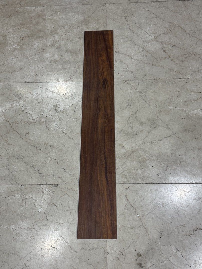 Dark brown wood SPC Interlocking Flooring (Category: Carpets, Mats & Flooring) located in Manila. Submitted by marquezpa52205 (Listing ID 1469710299, Image 1). Description: - Color/Finish: Rich dark brown with visible wood grain pattern - Material: Vinyl flooring plank with interlocking edges - Condition: Leftover piece from a recent home renovation - Ideal Use: Perfect for small DIY projects or quick flooring repairs - Quantity: 1 piece only.