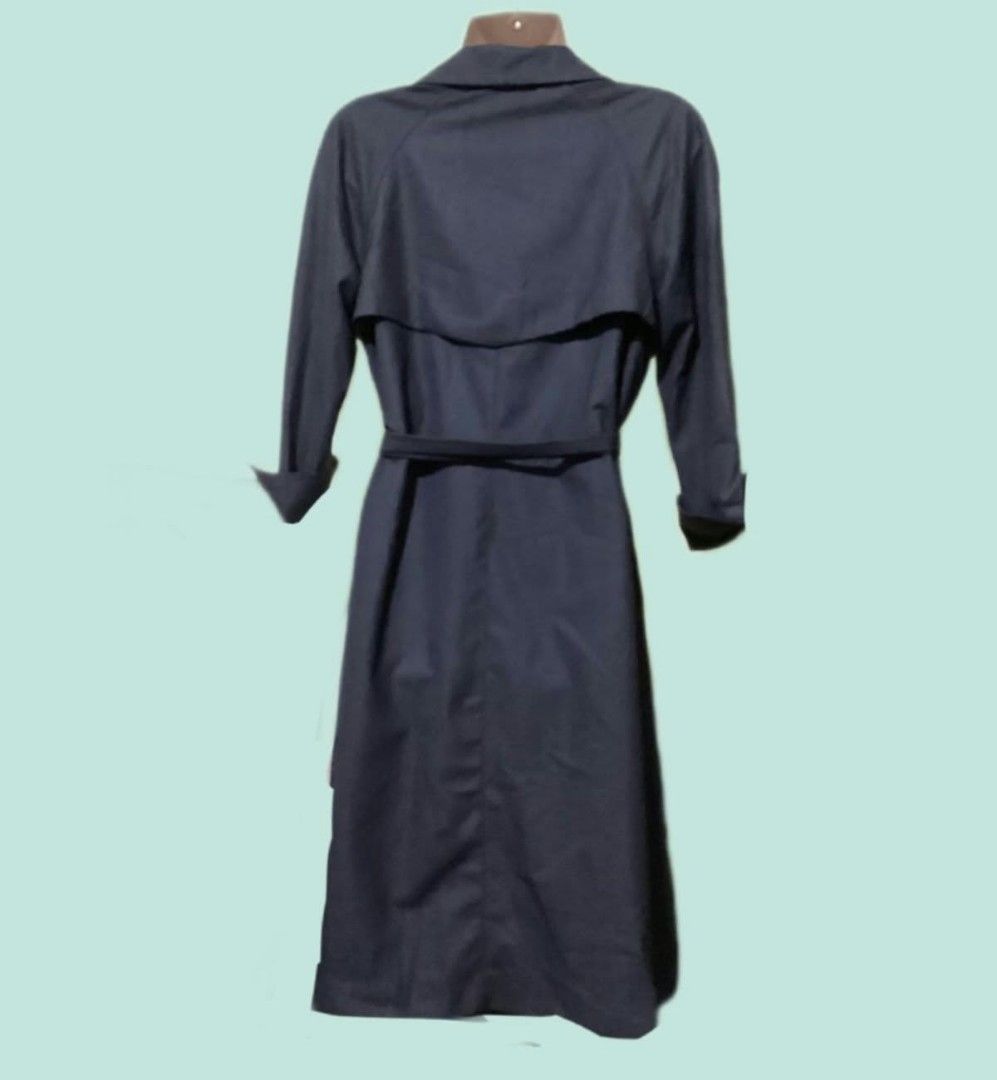 Dark Grey Trench Coat with Belt (Category: Coats, Jackets and Outerwear) located in Paranaque City. Submitted by calm_youngstore7 (Listing ID 1469614717, Image 2). Description: - Color: Dark grey - Style: Classic double-breasted trench coat with a clean look - Fit: Adjustable matching tie belt at the waist - Features: Long sleeves with folded cuffs and upper back storm flap - Length: Mid-length cut - Material: Lightweight and easy to style - Occa
