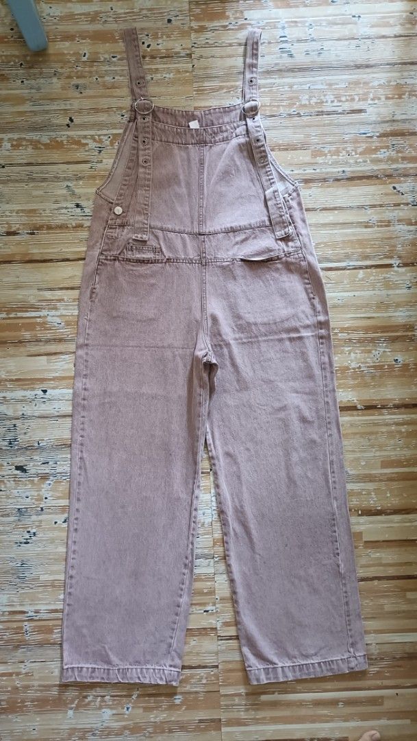 Denim Jumper Pants (Category: Jumpsuits) located in Dasmarinas. Submitted by kheiko086 (Listing ID 1469615689, Image 1). Description: W:34"L:37"Leg Hole:9.5" side zip/button adj strap hard denim EUC JNT Delivery - Style: Pink denim overalls with a relaxed wide-leg silhouette - Straps: Adjustable with metal O-rings and multiple eyelets - Pockets: Front bib pocket and two back patch pockets - Closure: Convenient side button closure - Fit: Comfortab