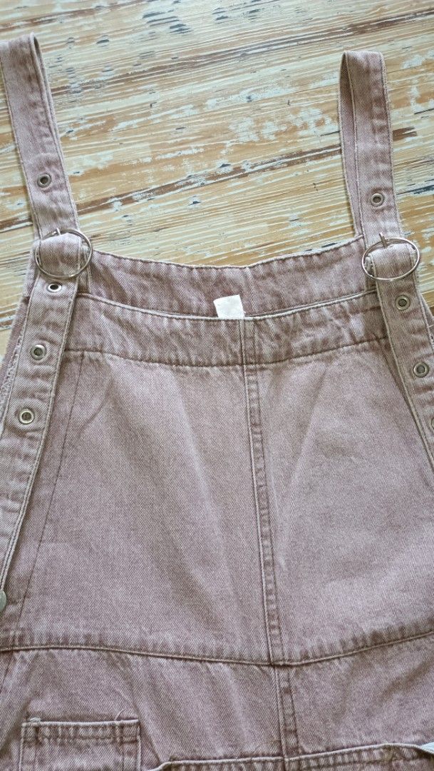 Denim Jumper Pants (Category: Jumpsuits) located in Dasmarinas. Submitted by kheiko086 (Listing ID 1469615689, Image 3). Description: W:34"L:37"Leg Hole:9.5" side zip/button adj strap hard denim EUC JNT Delivery - Style: Pink denim overalls with a relaxed wide-leg silhouette - Straps: Adjustable with metal O-rings and multiple eyelets - Pockets: Front bib pocket and two back patch pockets - Closure: Convenient side button closure - Fit: Comfortab
