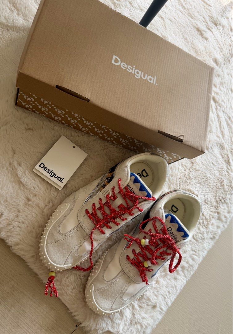 Desigual Retro Sneaker Heritage Patch EUR 39 authentic (Category: Sneakers) located in Manila. Submitted by sanmer25 (Listing ID 1469579805, Image 3). Description: - Brand: Desigual - Style: Retro sneakers with heritage patches and animal print side stripe - Color: Off-white with red patterned laces (beaded ends), blue jagged tongue trim, and silver metallic heel accents - Size: EUR 39 / US 8 / UK 6 - Sole: Textured rubber - Inclusions: Original 