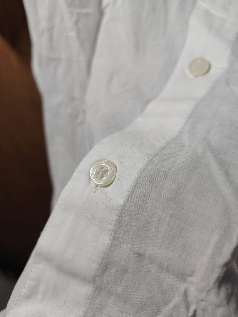D&G Junior White Button-Up Shirt (Category: Shirts) located in Baguio. Submitted by tabuzomaria1422 (Listing ID 1469699983, Image 3). Description: - Brand: D&G Junior - Color: Classic White - Style: Short-sleeve button-up shirt - Design: Large embroidered D&G logo lettering on the chest - Details: Branded buttons down the front and collar neckline - Origin: Made in Turkey - Care: Wash and iron inside out (tag instructions included) Need Wash Only