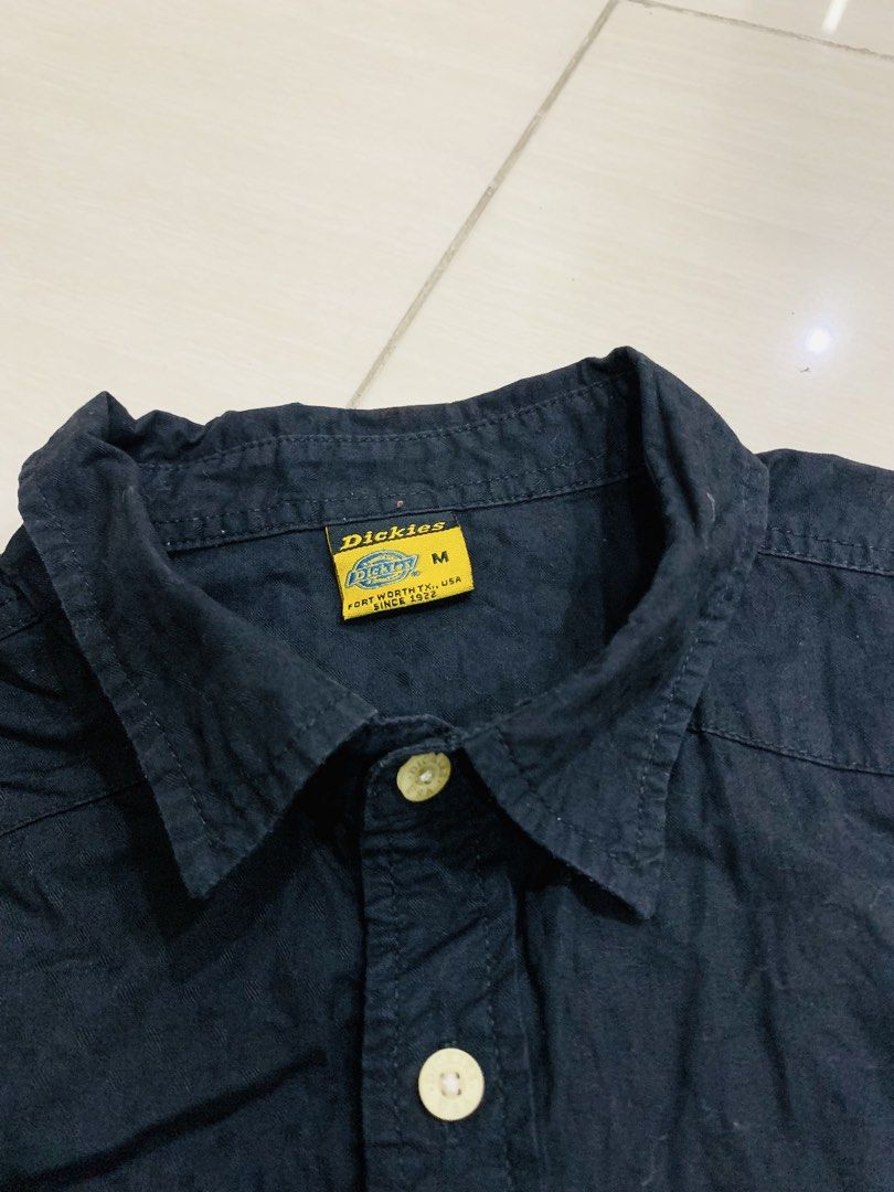 Dickies Black Short Sleeve Button Down Shirt Size M (Category: Tshirts & Polo Shirts ) located in Manila. Submitted by gizmolacaba (Listing ID 1469673087, Image 1). Description: - Brand: Dickies - Color: Solid black - Size: Medium - Style: Short sleeve button-down, classic workwear fit - Details: Dual chest pockets with button flaps and woven logo patch near the hem - Condition: Clean, excellent, ready to wear.