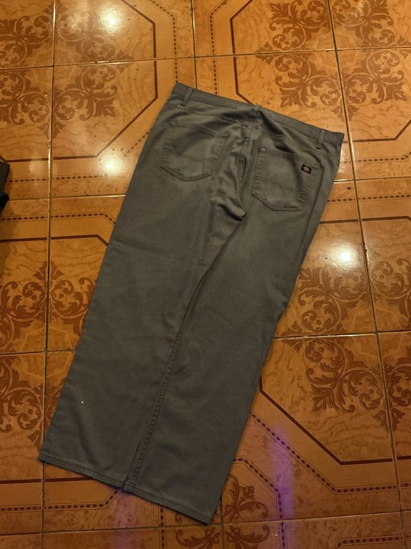 Dickies Grey Casual Pants (Category: Trousers) located in Manila. Submitted by cualesdyla42584 (Listing ID 1469659409, Image 1). Description: - Brand: Dickies - Color: Grey - Style: Casual pants with classic and belt loops - Details: Small Signature Dickies logo patch on the back pocket - Condition: Pre-owned, has visible stains on the front lower leg area and back pockets, needs a good wash - Price reflects condition, perfect for everyday beater