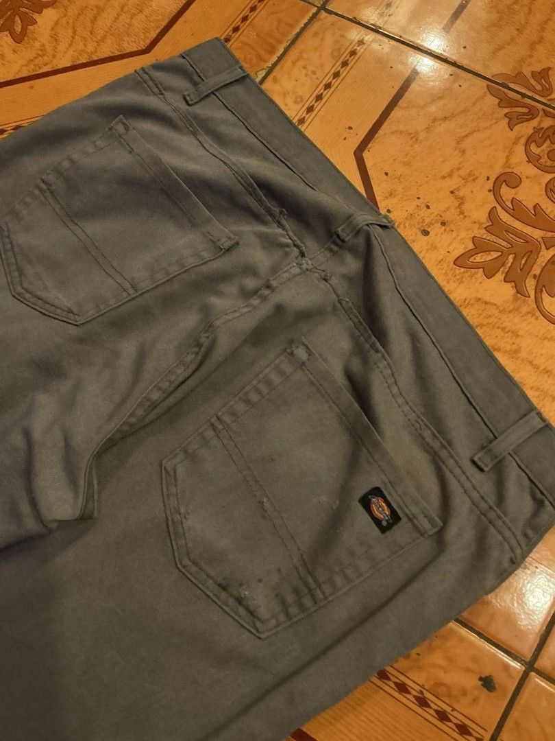 Dickies Grey Casual Pants (Category: Trousers) located in Manila. Submitted by cualesdyla42584 (Listing ID 1469659409, Image 2). Description: - Brand: Dickies - Color: Grey - Style: Casual pants with classic and belt loops - Details: Small Signature Dickies logo patch on the back pocket - Condition: Pre-owned, has visible stains on the front lower leg area and back pockets, needs a good wash - Price reflects condition, perfect for everyday beater
