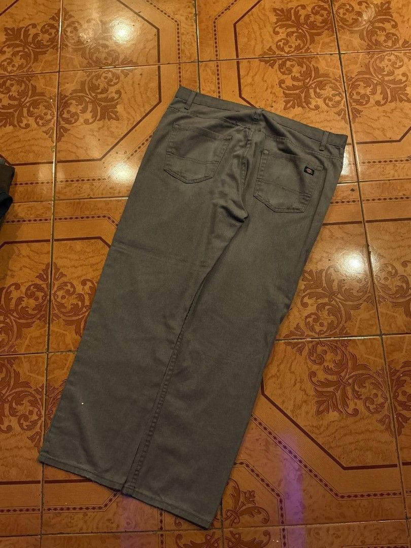 Dickies Grey Casual Pants (Category: Trousers) located in Manila. Submitted by cualesdyla42584 (Listing ID 1469659409, Image 3). Description: - Brand: Dickies - Color: Grey - Style: Casual pants with classic and belt loops - Details: Small Signature Dickies logo patch on the back pocket - Condition: Pre-owned, has visible stains on the front lower leg area and back pockets, needs a good wash - Price reflects condition, perfect for everyday beater