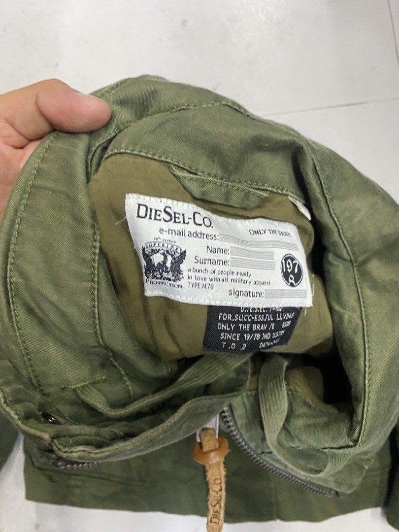 Diesel Green Military Cargo Jacket (Category: Activewear) located in Alburquerque. Submitted by zanegavynn43872 (Listing ID 1469585647, Image 2). Description: - Brand: Diesel - Style: Green military utility jacket - Material: 98% cotton, 2% elastane with cow leather accents - Features: Four front flap pockets, secure zip closure with pull tab, shoulder epaulets - Origin: Made in India - Condition: Excellent.