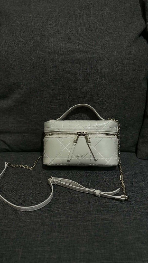 Dior Travel Vanity Case White Cannage (Category: Luxury Bags & Wallets) located in Cavite. Submitted by loriojenni09117 (Listing ID 1469711643, Image 1). Description: - Dior vanity bag in clean white leather - Classic cannage stitching with elegant gold-tone hardware and Dior logo zippers - Structured shape with a convenient top handle - Versatile: includes both a chic chain strap and an adjustable leather shoulder strap - Stamped 'Dior Made in I