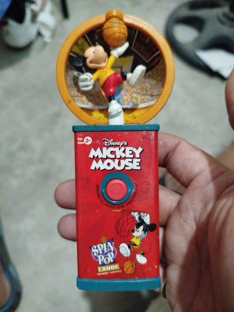 Disney Mickey Mouse Spin Pop Candy Basketball Toy 2002 (Category: Kids Toys) located in Subic. Submitted by regiedaniel01 (Listing ID 1469580985, Image 1). Description: - Vintage 2002 Disney Mickey Mouse Spin Pop candy toy - Basketball-themed design with Mickey figure in an orange hoop - Red body featuring Spin Pop branding and graphics - Powered by AA batteries - Perfect collectible item for Disney and vintage toy fans.