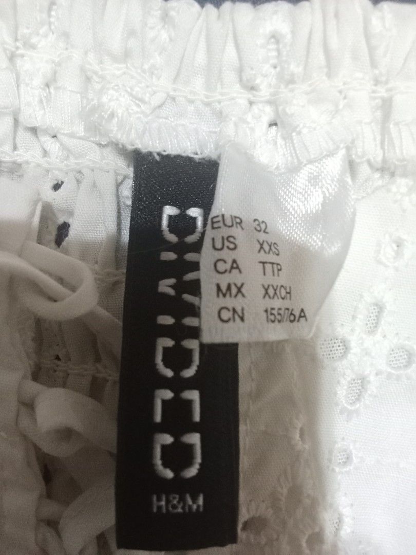 Divided by H&M Cropped Top (Category: Others Tops) located in Quezon City. Submitted by wisdomsophia (Listing ID 1469597942, Image 3). Description: Eyelet Design with Garterized Back Color: White Width: 14.5".