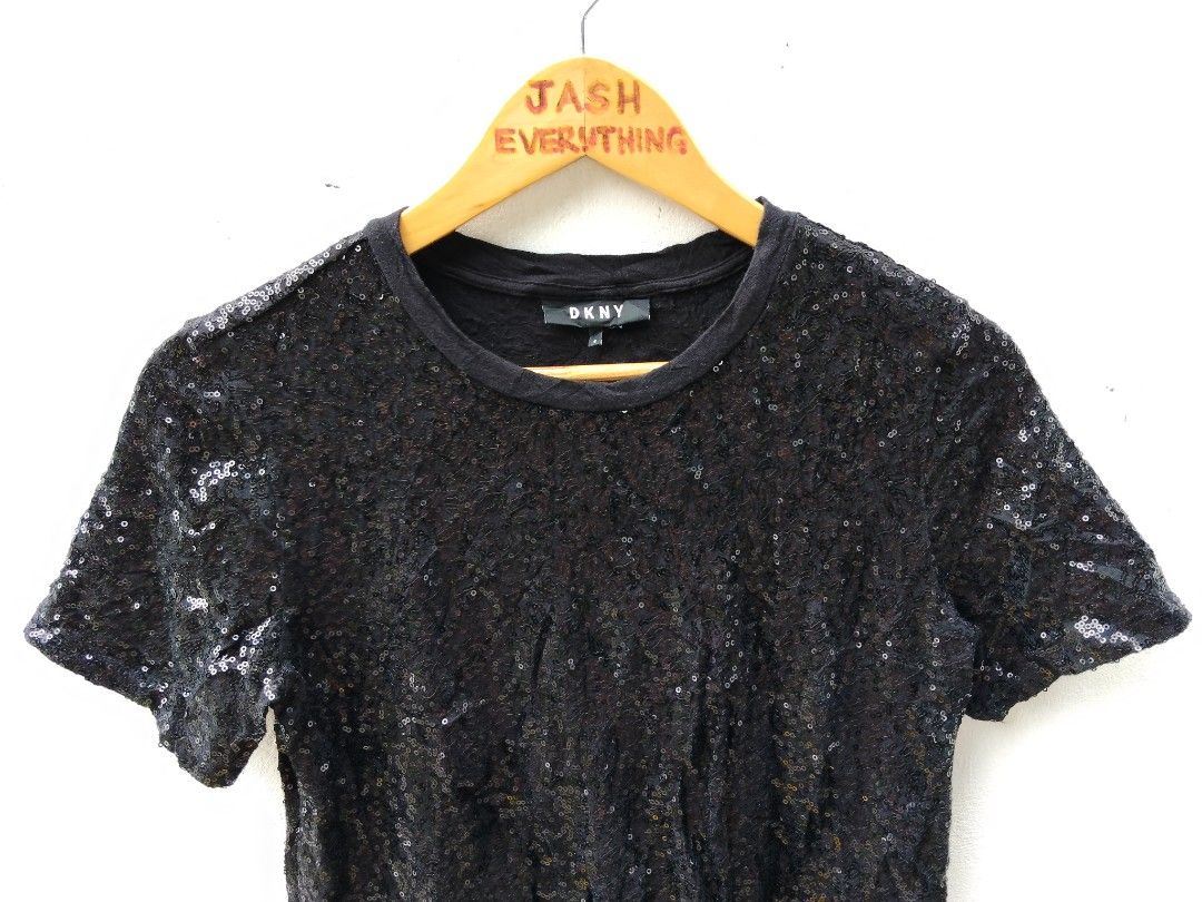 DKNY Black Sequin Short Sleeve T-Shirt (Category: Shirts) located in City of Isabela. Submitted by jasheverything (Listing ID 1469719463, Image 2). Description: - Brand: DKNY - Style: Short sleeve t-shirt covered in small sequins (front and back) - Color: Black - Size: Small - Material: 95% cotton, 5% spandex (soft with a bit of stretch) - Neckline: Ribbed crew neck - Care Instructions: Machine wash cold, gentle cycle Excellent Condition No Issue