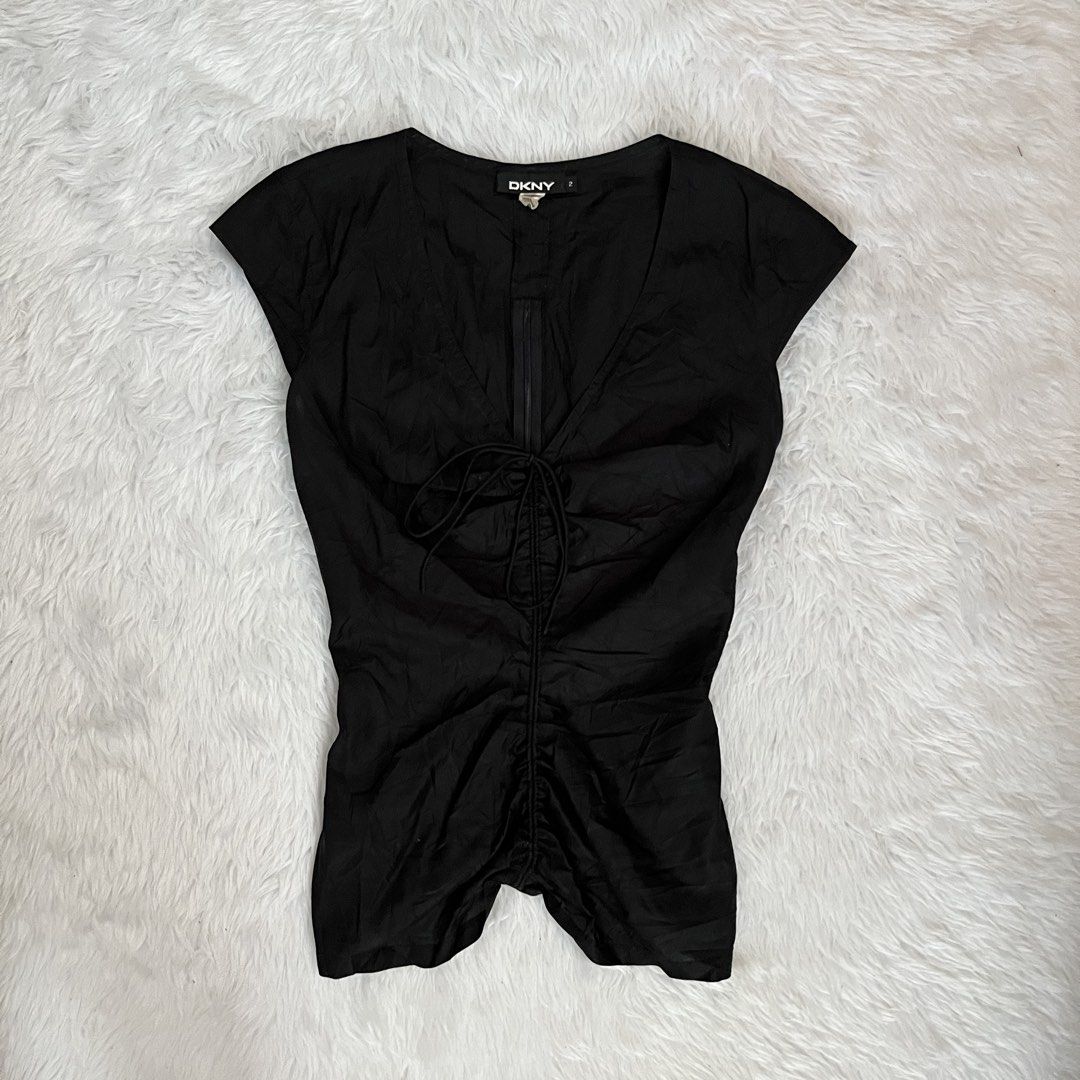 DKNY Black V-Neck Ruched Front Top Size 2 (Category: Blouses) located in Maasin. Submitted by taraa18 (Listing ID 1469584160, Image 1). Description: - Brand: DKNY - Size: 2 - Color: Classic Black - Neckline: Deep V-neck - Details: Adjustable drawstring ruching down the front - Fit: Fitted silhouette, lightweight fabric, and cap sleeves - Condition: Excellent, clean inner label.