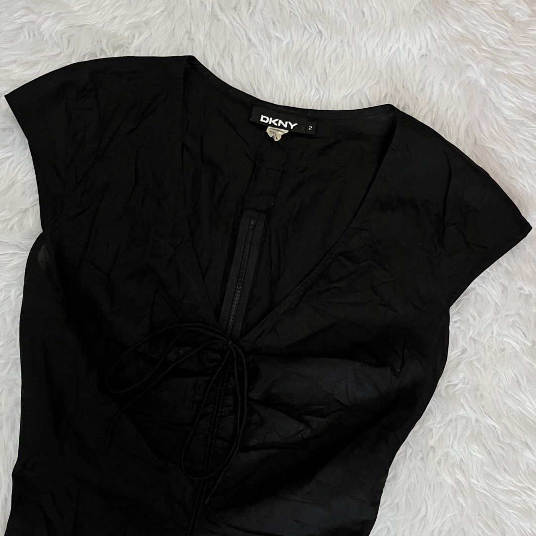 DKNY Black V-Neck Ruched Front Top Size 2 (Category: Blouses) located in Maasin. Submitted by taraa18 (Listing ID 1469584160, Image 2). Description: - Brand: DKNY - Size: 2 - Color: Classic Black - Neckline: Deep V-neck - Details: Adjustable drawstring ruching down the front - Fit: Fitted silhouette, lightweight fabric, and cap sleeves - Condition: Excellent, clean inner label.