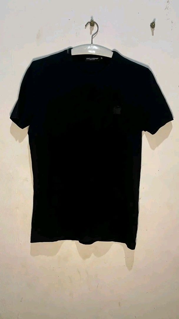 Dolce & Gabbana Black T-Shirt (Category: Shirts) located in San Jose. Submitted by garments17 (Listing ID 1469694603, Image 1). Description: - Brand: Dolce & Gabbana - Color: Classic Black - Design: Short sleeves, standard crew neck cut - Detail: Small logo patch on the left chest - Condition/Fit: Clean solid color, tag size visible at collar - Style: Great for casual, daily outfits.