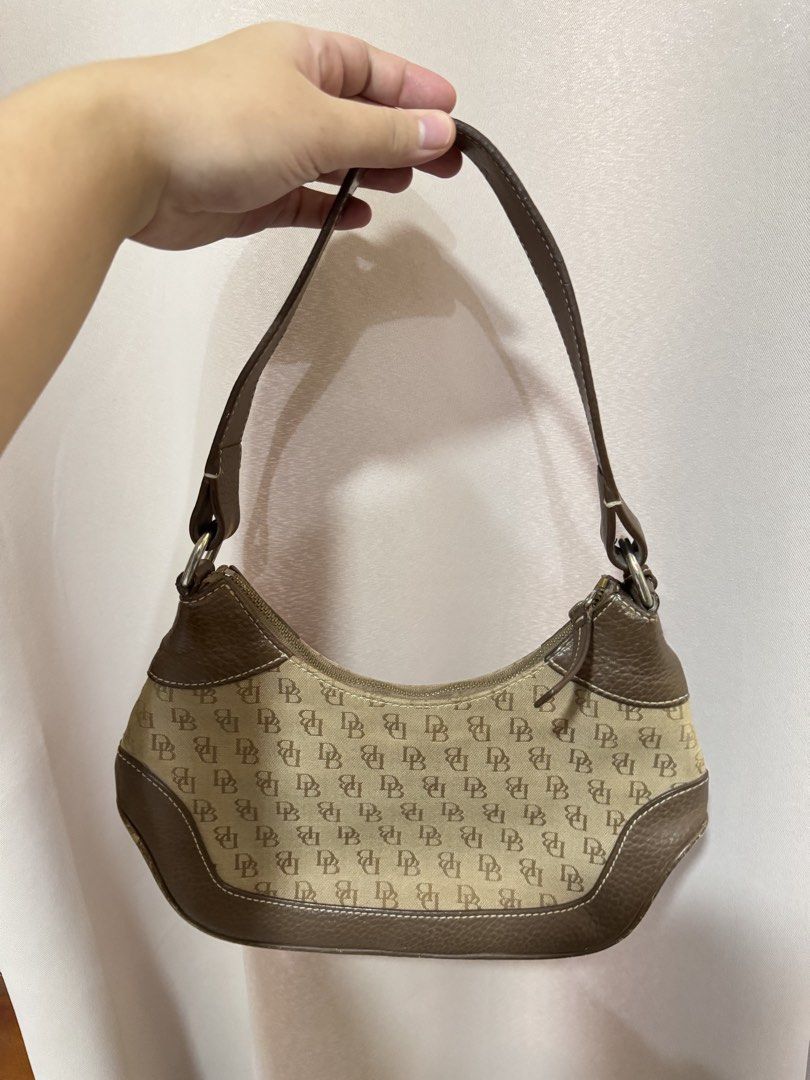 Dooney & Bourke Monogram Shoulder Bag Brown (Category: Luxury Bags & Wallets) located in Tagbilaran City. Submitted by neinjah (Listing ID 1469583086, Image 2). Description: - Authentic Dooney & Bourke shoulder bag - Brown monogram jacquard canvas with all-over DB print - Brown textured leather trim and matching single strap - Secure top zip closure with leather zipper pull - Interior features a zipper pocket and a convenient key leash - Flaw: Ha