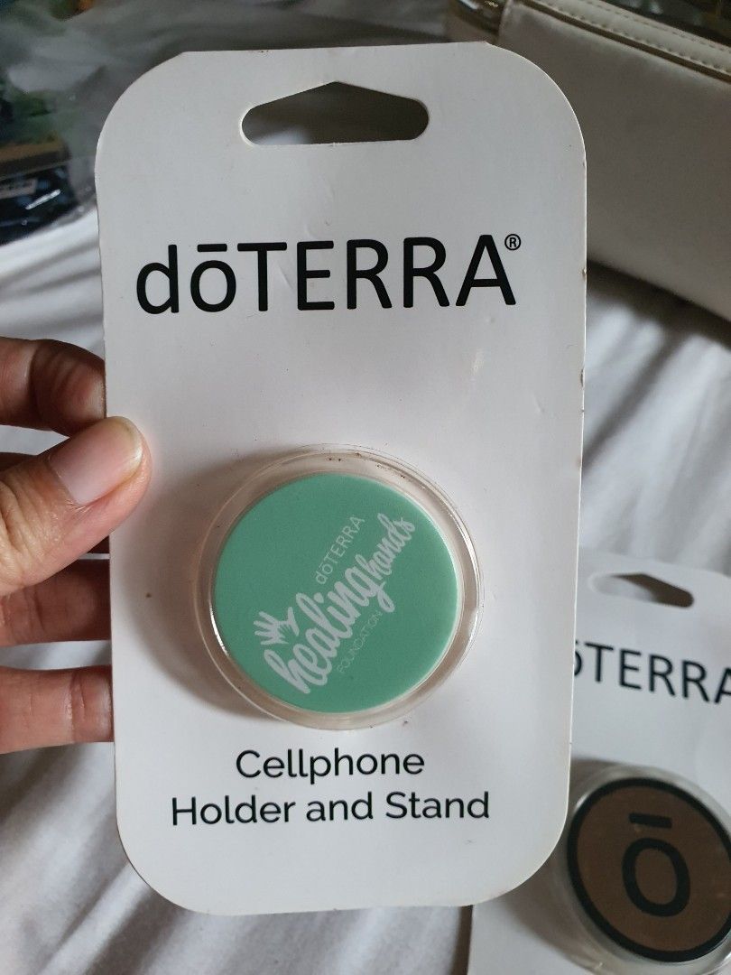 Doterra Cellphone holder/stand (Category: Everything Else Others) located in Paranaque City. Submitted by nicessities (Listing ID 1469638109, Image 2). Description: dōTERRA Cellphone Holder/Stand collectible Php 250 each purchased personally from US during doterra convention brand new, never used excess.