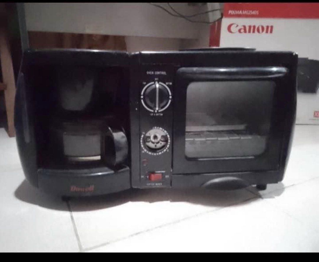 Dowell 3-in-1 Coffee Maker Toaster Oven Black (Category: Ovens & Toasters) located in Manila. Submitted by eacosta16227721 (Listing ID 1469620163, Image 1). Description: - Brand/Model: Dowell Multi-function Breakfast Station (Black) - Features: Coffee maker, toaster oven, and top warming surface all in one - Condition: Working fine, well-maintained - Space Saver: Compact design ideal for small kitchens, dorm rooms, or condos - Included Accessorie